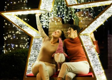 Two women sitting in a lit up star